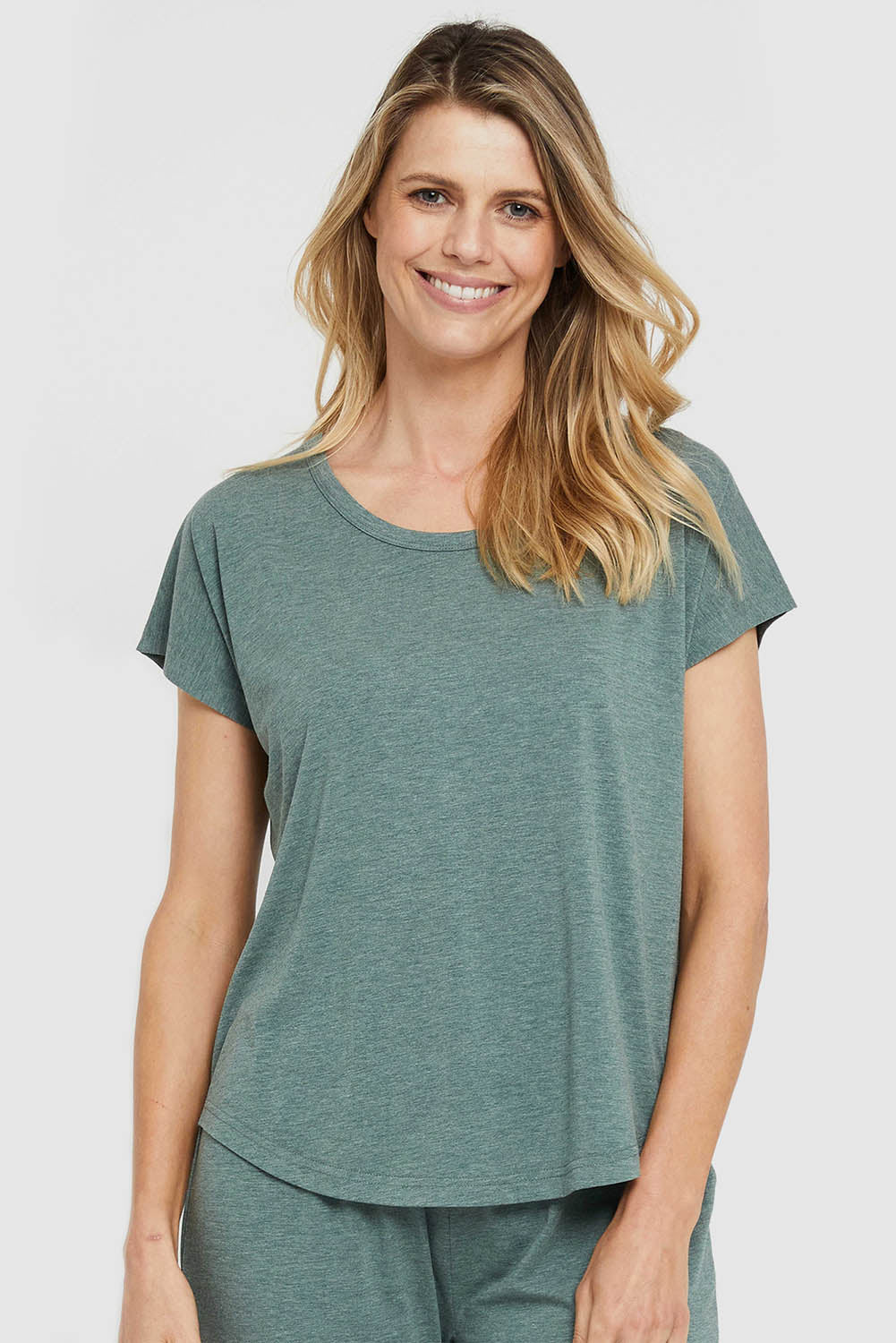 A model wearing the Lounge Bamboo Tee in colour Moss (Green), from the front, cropped image