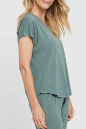 A model wearing the Lounge Bamboo Tee in colour Moss (Green), from the front, cropped image