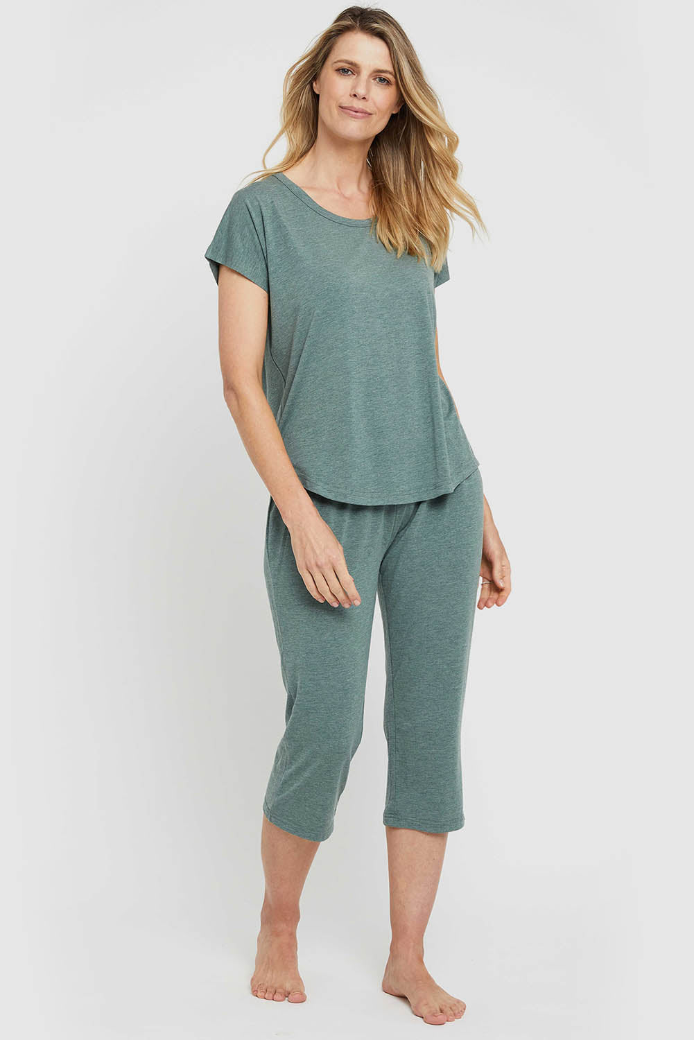 A model wearing the Lounge Bamboo Tee in colour Moss (Green), from the front, showing the whole outfit
