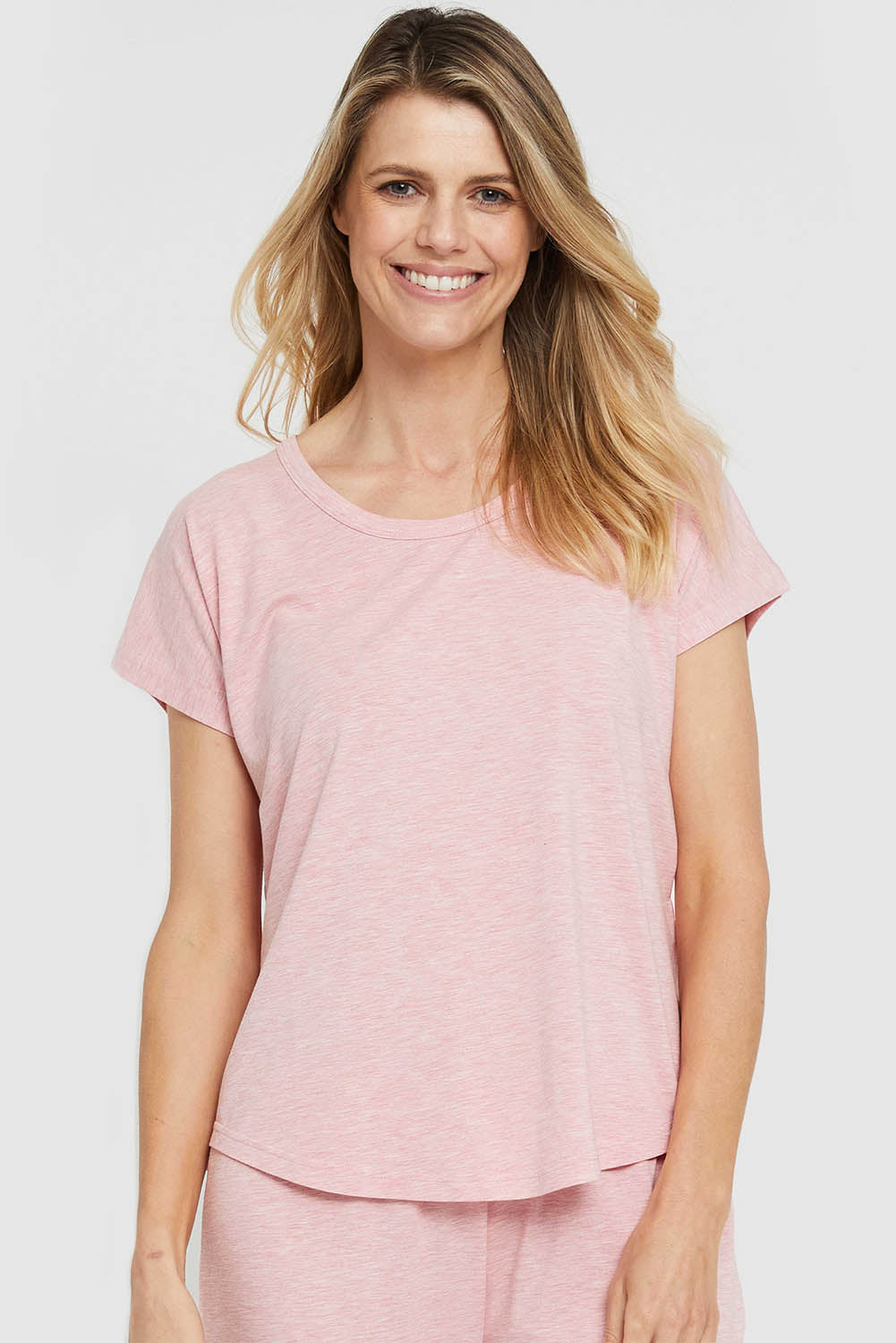 A model wearing the Lounge Bamboo Tee in colour Rose (Pink), from the front, cropped image
