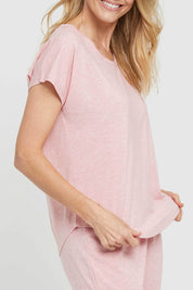 A model wearing the Lounge Bamboo Tee in colour Rose (Pink), from the front, cropped image