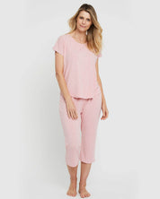A model wearing the Lounge Bamboo Tee in colour Rose (Pink), from the front, showing the whole outfit
