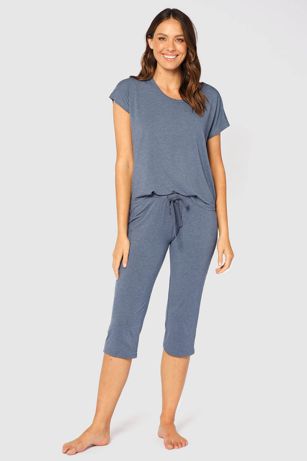 A model wearing the Lounge Bamboo Tee in colour Twilight (Blue), from the front, showing the whole outfit