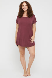 A model wearing the Bamboo Nightie in colour Burgundy (Red), from the front, showing the whole outfit