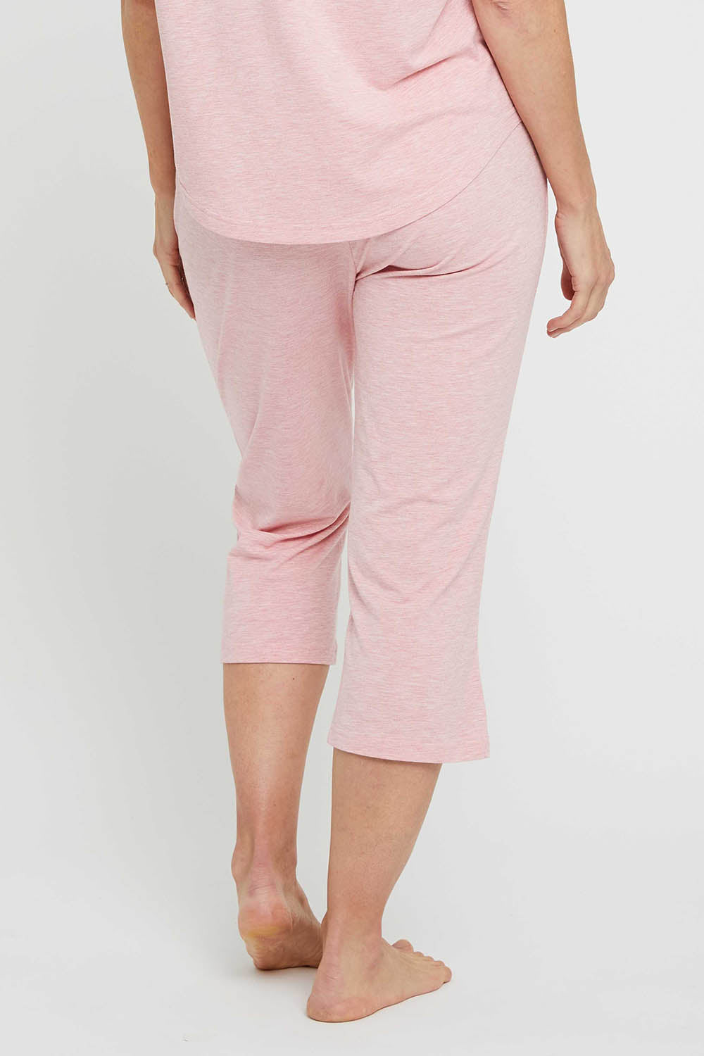 A model wearing the 3/4 Bamboo PJ Pant in colour Rose (Pink), from the back