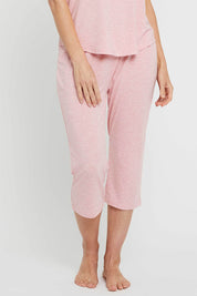 A model wearing the 3/4 Bamboo PJ Pant in colour Rose (Pink), from the front, cropped image