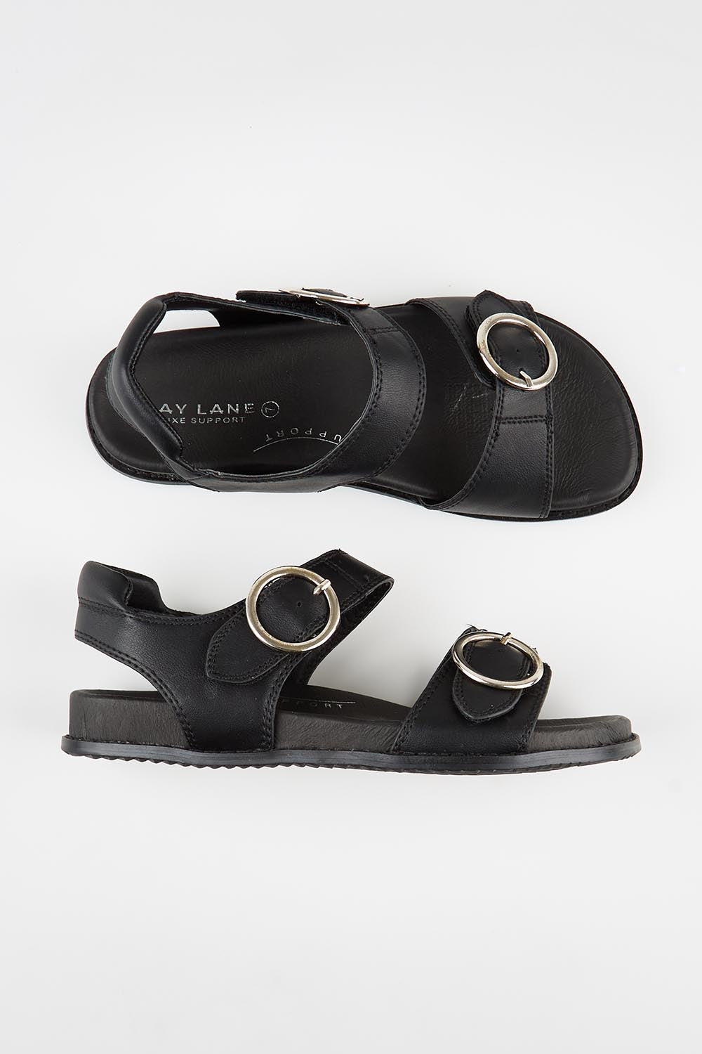 Model Genericm wearing size sample of the Molly Leather Velcro Slide - Black in colour Black, from an angle