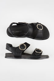 Model Genericm wearing size sample of the Molly Leather Velcro Slide - Black in colour Black, from an angle