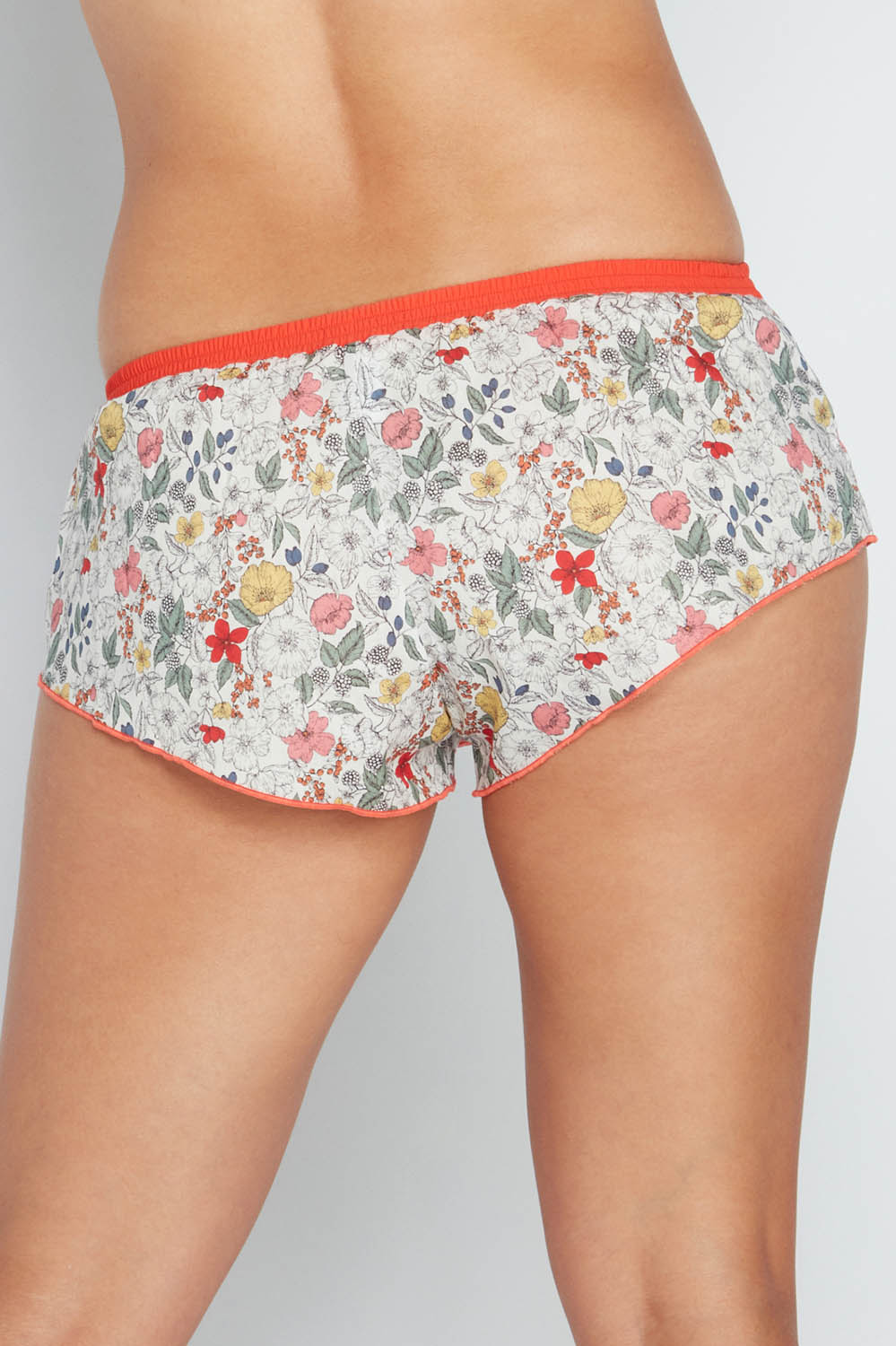 A model wearing the Liberty Bramble Short in colour Fiestabrum (Red), from the back