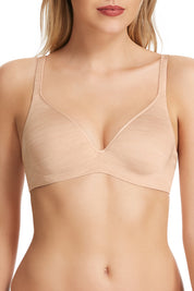 A model wearing the Barely There Contour Bra in colour Skin, from the front, cropped image