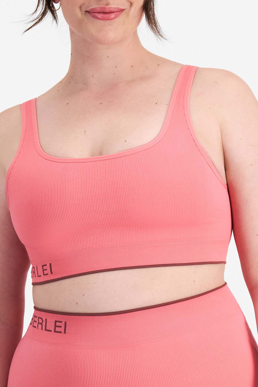 A model wearing the Act Seamless Scoop in colour Rosetea (Pink), from the front, cropped image
