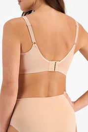 A model wearing the Postin colourSurgery Recovery Bra - Nude, from the back
