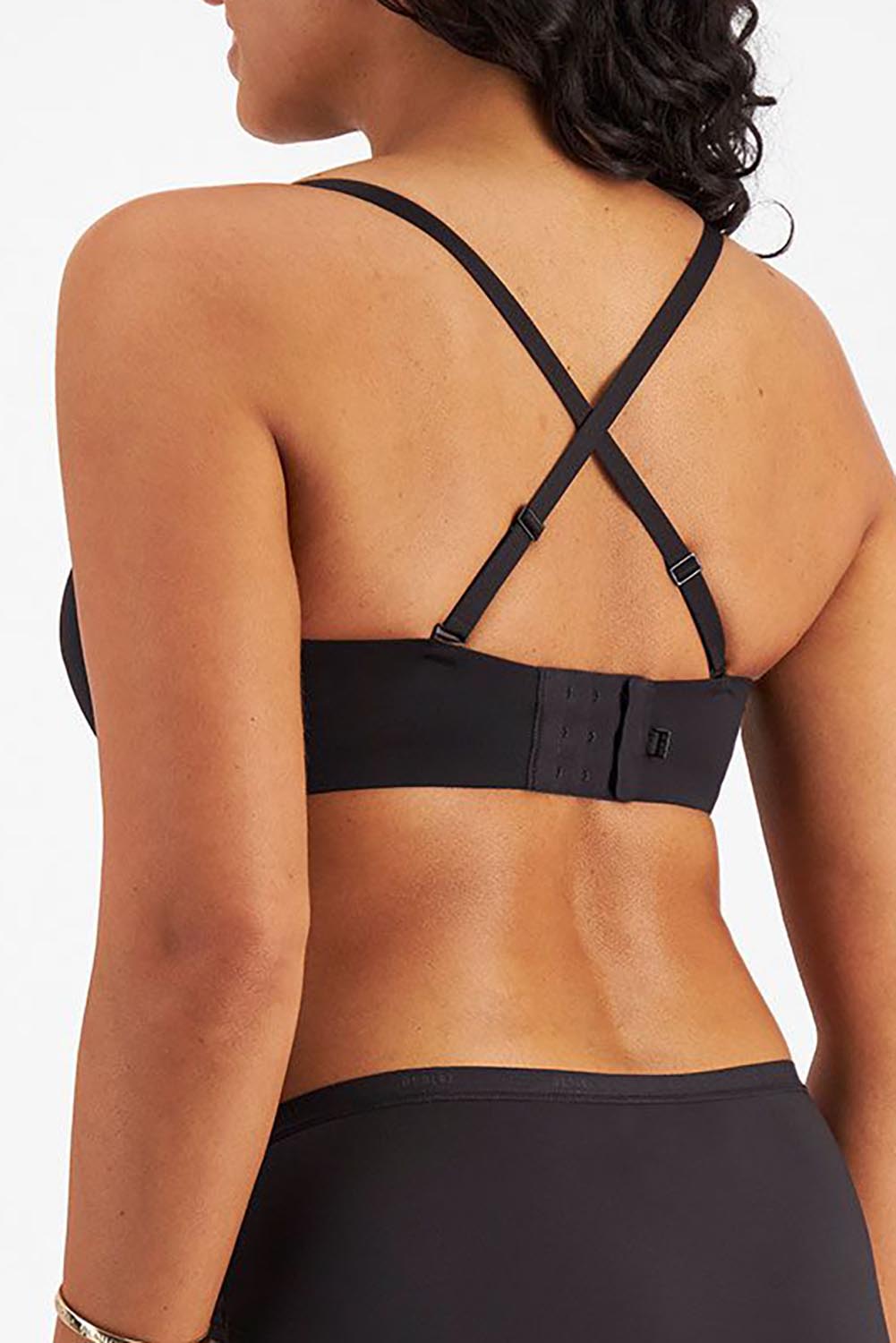 A model wearing the Luminous Strapless Bra in colour Black (Black), from the back