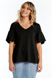 A model wearing the Alessi Frill Top in colour Black (Black), from the front, cropped image
