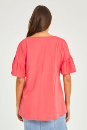 Model Elhana wearing size 10 of the Alessi Frill Top in colour Strawberry (Pink), from the back