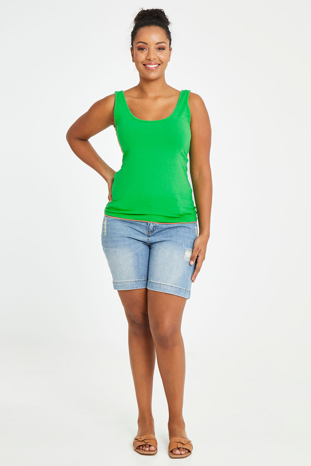 Model Noli wearing size 14 of the Emma Tank in colour Kiwi (Green), from the front, showing the whole outfit