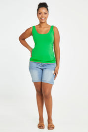 Model Noli wearing size 14 of the Emma Tank in colour Kiwi (Green), from the front, showing the whole outfit