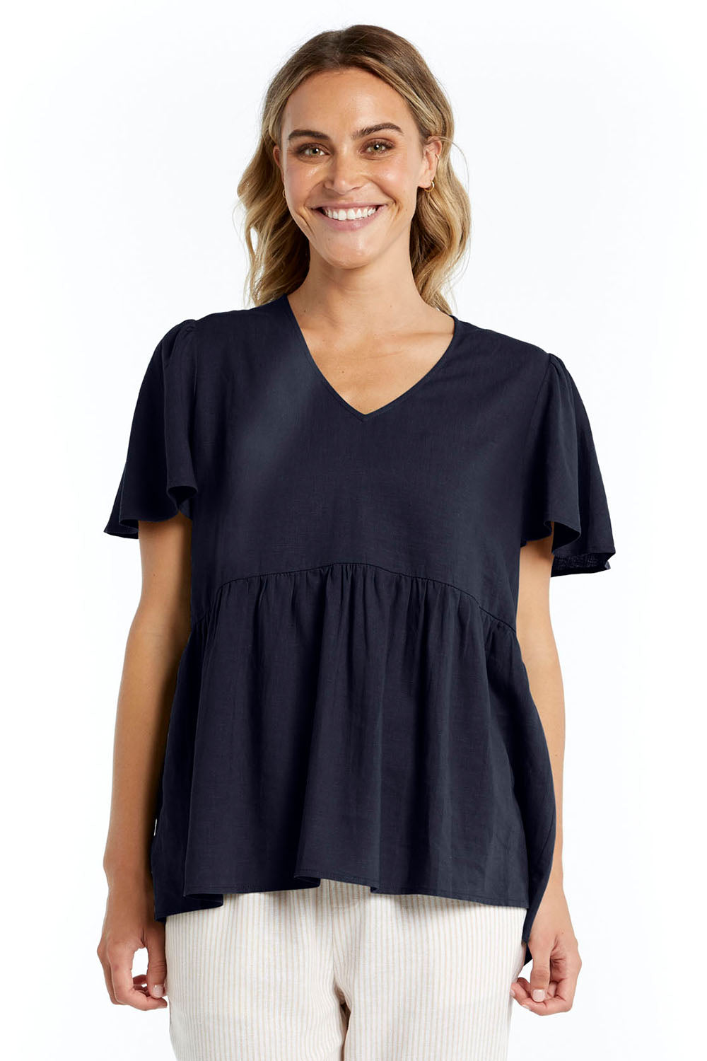A model wearing the Abigail Blouse in colour Nigshadow (Blue), from the front, cropped image
