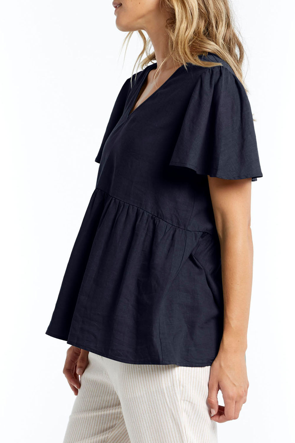 A model wearing the Abigail Blouse in colour Nigshadow (Blue), from the front, cropped image