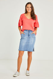 Model Elhana wearing size 10 of the Avici Denim Skirt in colour Lightsky (Blue), from the front, showing the whole outfit