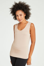 Model Olivia wearing size 10 of the Liza Tank in colour Nude, from the front, cropped image