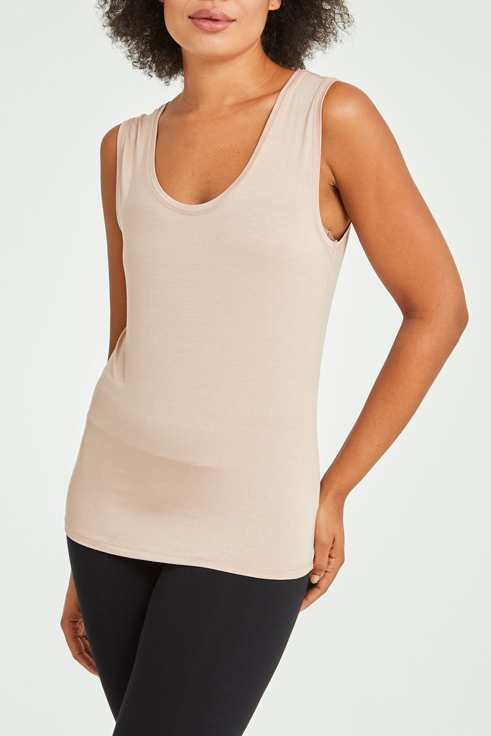 Model Olivia wearing size 10 of the Liza Tank in colour Nude, from the front, cropped image