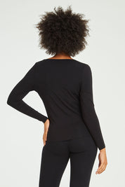 Model Olivia wearing size 10 of the Kelli Long Sleeve Top in colour Black (Black), from the back