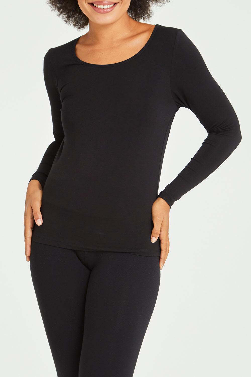 Model Olivia wearing size 10 of the Kelli Long Sleeve Top in colour Black (Black), from the front, cropped image