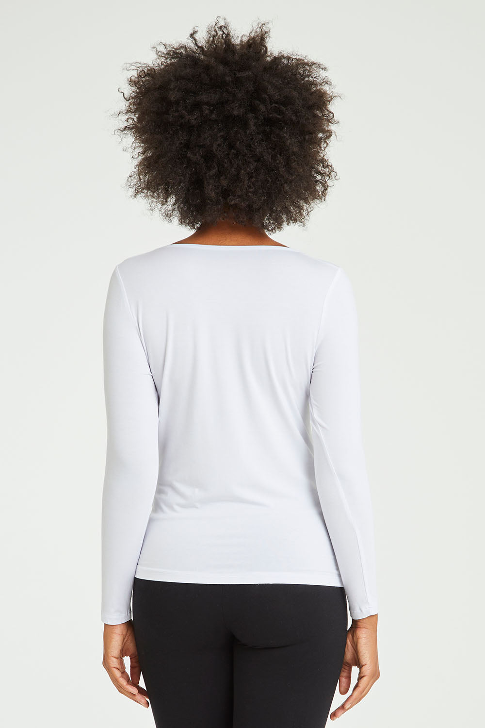 Model Olivia wearing size 10 of the Kelli Long Sleeve Top in colour White (White), from the back