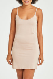 Model Olivia wearing size 10 of the Roxie Reversible Slip in colour Nude, from the front, cropped image