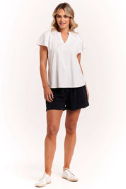 A model wearing the Bree Tin colourShirt - White (White), from the front, showing the whole outfit
