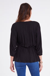 Model Madeline wearing size 10 of the Bayeaux Wrap Top in colour Black (Black), from the back