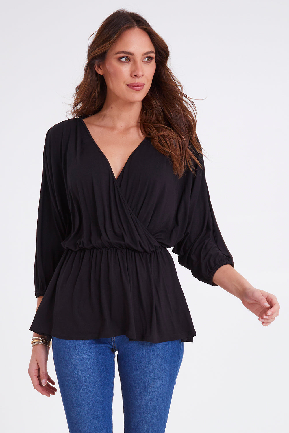 Model Madeline wearing size 10 of the Bayeaux Wrap Top in colour Black (Black), from the front, cropped image