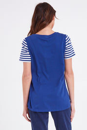Model Madeline wearing size 10 of the Luella Tee in colour Oceanstrip (Blue), from the back