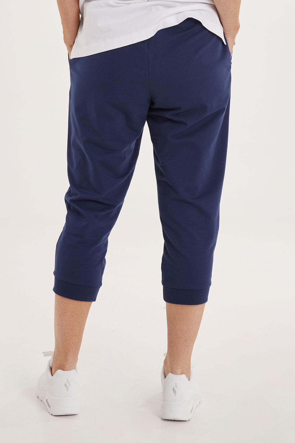 Model Sally wearing size 10 of the Tasha Crop Jogger in colour Navy (Blue), from the back
