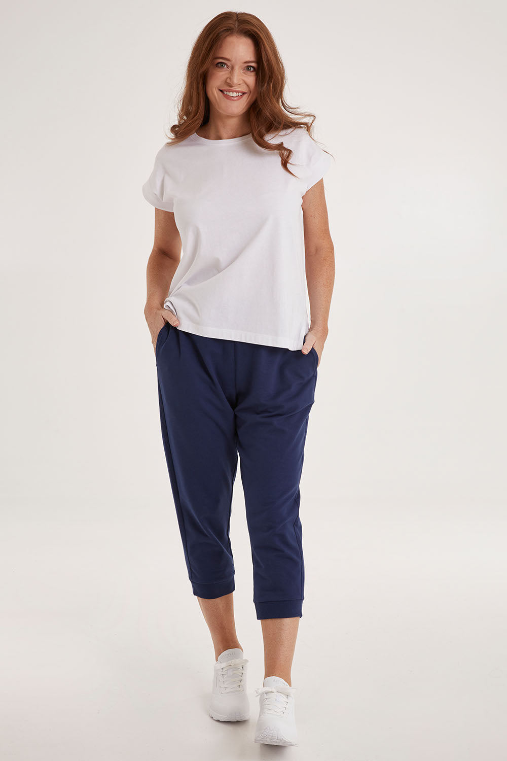 Model Sally wearing size 10 of the Tasha Crop Jogger in colour Navy (Blue), from the front, showing the whole outfit