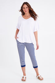 Model Madeline wearing size 10 of the Tasha Crop Jogger in colour Oceanstrip (Blue), from the front, showing the whole outfit