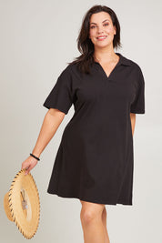 Model Poppy wearing size 16 of the Deana Polo Dress in colour Black (Black), from the front, cropped image