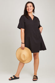 Model Poppy wearing size 16 of the Deana Polo Dress in colour Black (Black), from the front, showing the whole outfit
