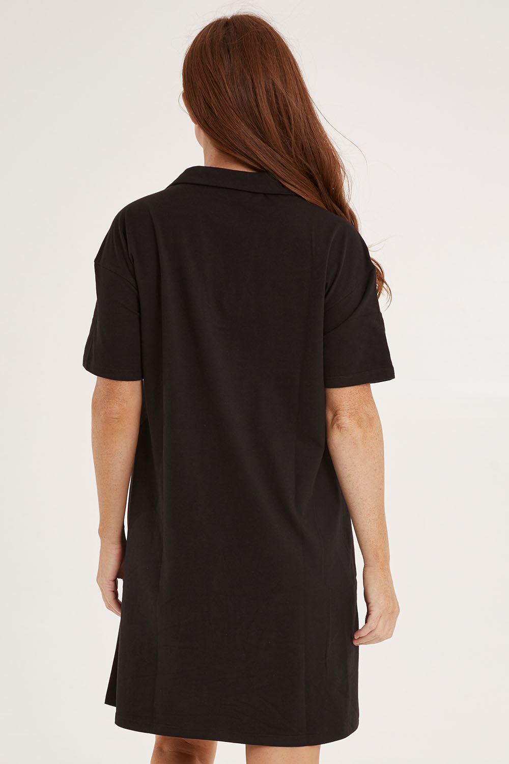 Model Sally wearing size 10 of the Deana Polo Dress in colour Black (Black), from the back