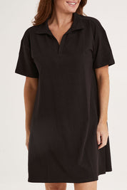 Model Sally wearing size 10 of the Deana Polo Dress in colour Black (Black), from the front, cropped image