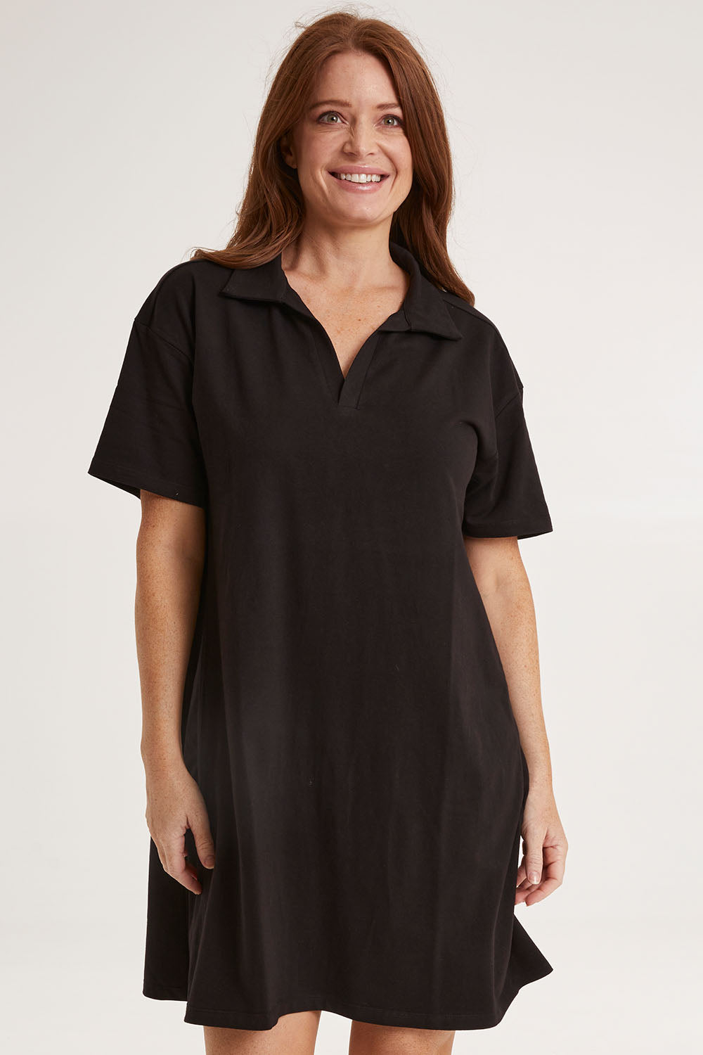 Model Sally wearing size 10 of the Deana Polo Dress in colour Black (Black), from the front, cropped image