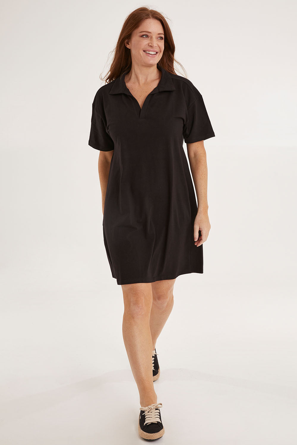 Model Sally wearing size 10 of the Deana Polo Dress in colour Black (Black), from the front, showing the whole outfit