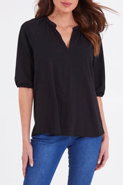 Model Madeline wearing size 10 of the Prue Tee in colour Black (Black), from the front, cropped image