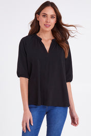 Model Madeline wearing size 10 of the Prue Tee in colour Black (Black), from the front, cropped image