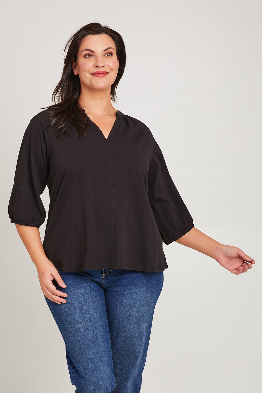 Model Poppy wearing size 16 of the Prue Tee in colour Black (Black), from the front, cropped image