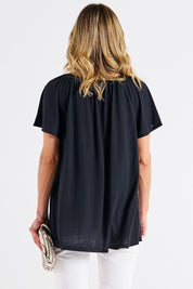A model wearing the Coral Bamboo Shirred Tee in colour Black (Black), from the back