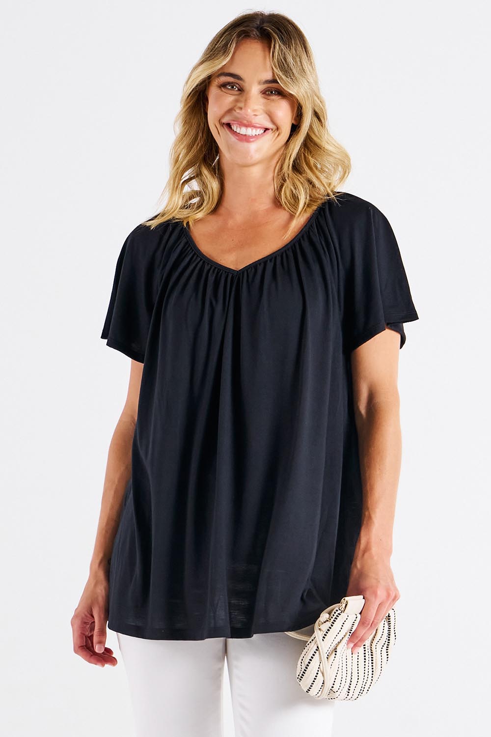 A model wearing the Coral Bamboo Shirred Tee in colour Black (Black), from the front, cropped image