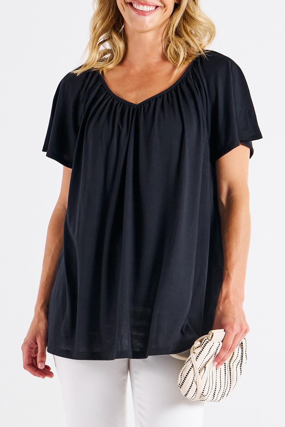 A model wearing the Coral Bamboo Shirred Tee in colour Black (Black), from the front, cropped image