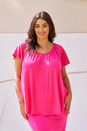 A model wearing the Coral Bamboo Shirred Tee in colour Pink (Pink), from the front, showing the whole outfit